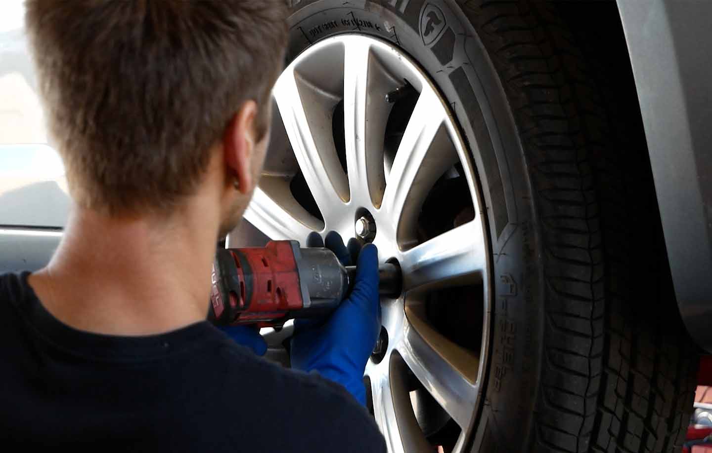 Mechanic removing a tire from a vehicle