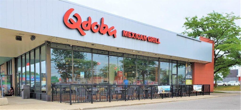 Photo of the Qdoba restaurant's side patio seating area