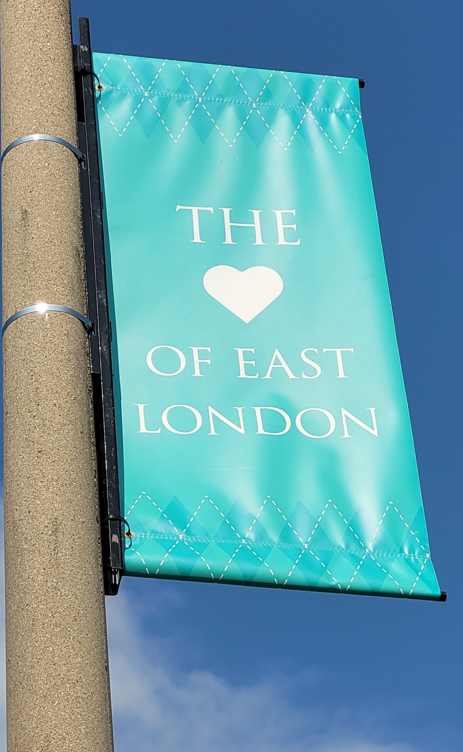 a telephone pole with an Argyle BIA branded vinyl banner attached